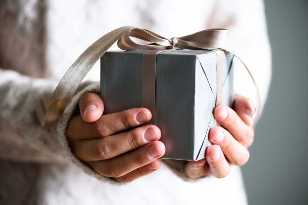 Female hands holding gift box. Copy space. Christmas, hew year, birthday concept